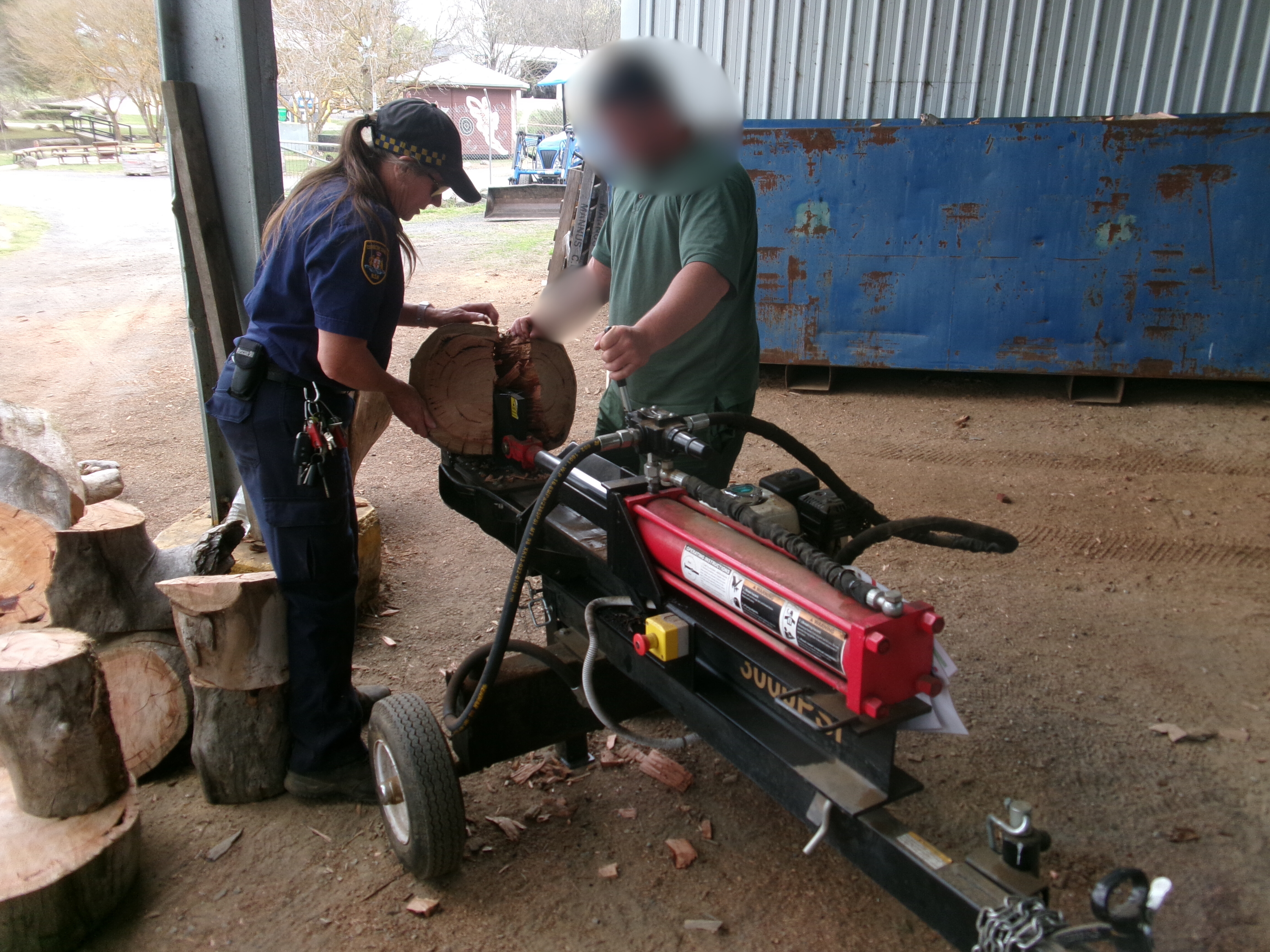 A man and woman chopping wood