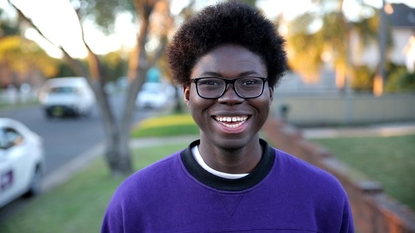 Portrait of Daniel smiling at the camera with the background blurred out
